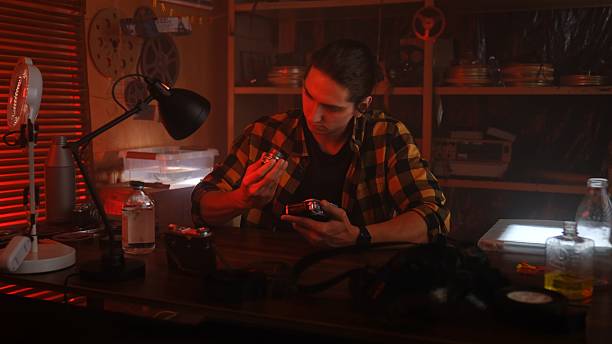 istock Young Man in Retro Studio with Film Equipment Present 2215592601