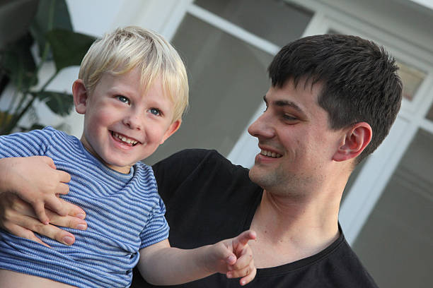 istock young  man with  his little boy outdoors having fun 2215593361