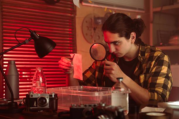 istock Young Photographer Developing Film In Darkroom Setting 2215597107