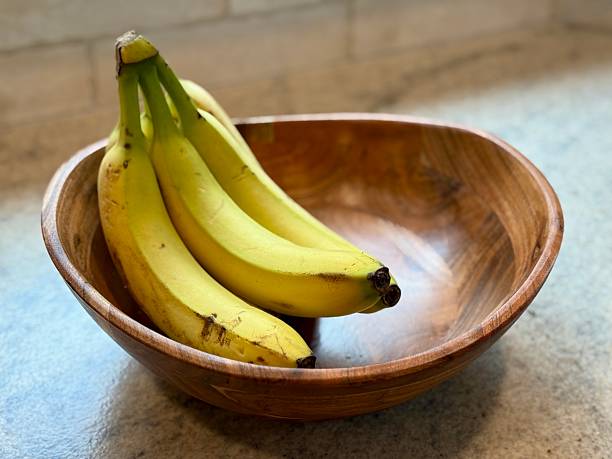istock Banana in wooden Bowl 2215597734