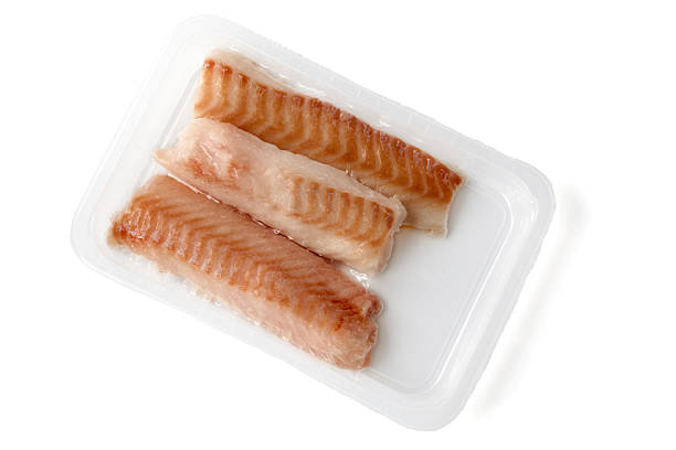 quick shock frozen cod fillet in vacuum packaging isolated on white background.