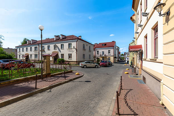 istock Sunny Historic Courtyard with Parked Cars 2215600006