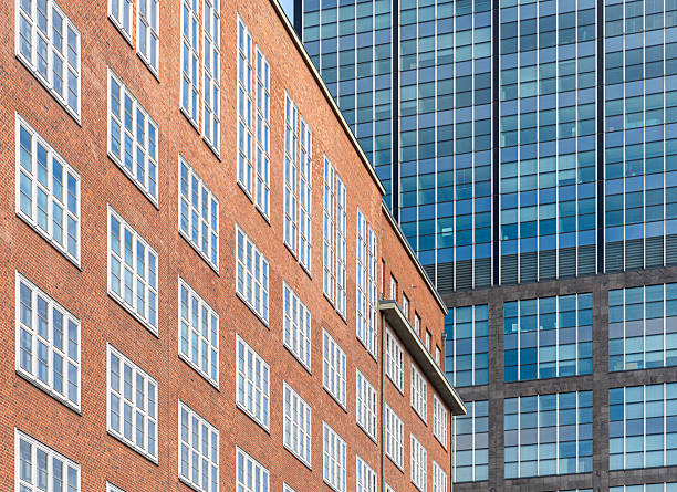 istock Old office building in front of a modern office building 2215600062