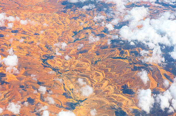 istock Arid landscape stretches beneath sky dotted with clouds 2215601059