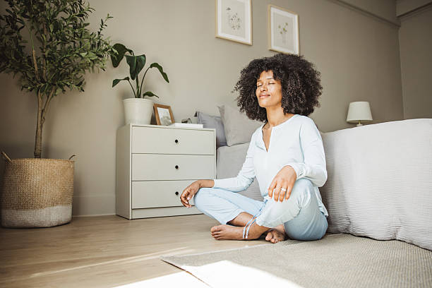 istock Relaxed black woman meditating during morning on a bed 2215601687