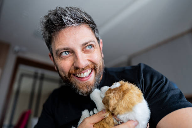 istock Smiling man enjoying playful moment with his pet 2215602536