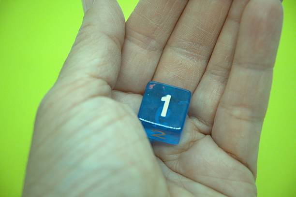 istock Blue dice with number 1 and green background 2215605358