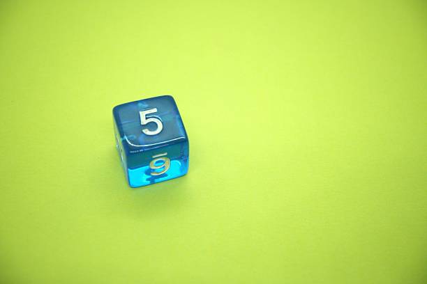Blue dice with number 5 and green background