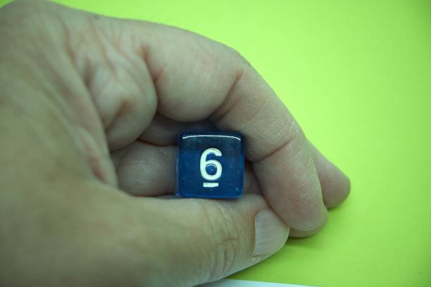 istock Blue dice with number 6 and green background 2215605495