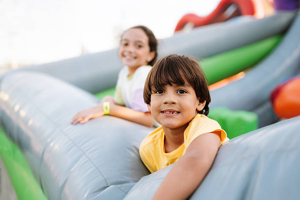 istock Children smiling at the camera on an inflatable toy 2215620177