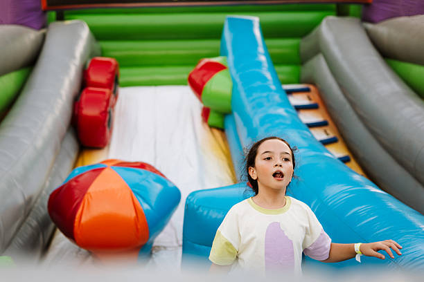 istock Young girl in inflatable amusement park 2215620194