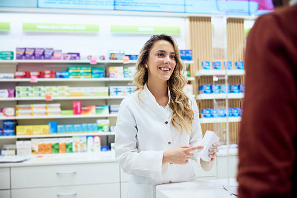 istock Friendly Pharmacist Assisting a Customer in a Modern Retail Pharmacy 2215622822