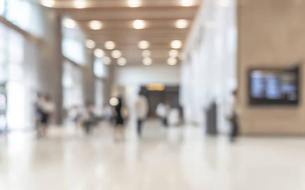 istock Blurred office building lobby or hotel blur background interior view toward reception hall, modern luxury lounge, white room space with blurry corridor and building glass wall 2215629056