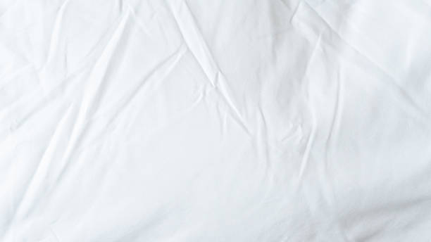 istock White bedsheet background, bed sheet texture, wrinkled duvet, crumpled satin blanket comforter cloth used in hotel, resort or home interior for bedding sleep comfort 2215629114