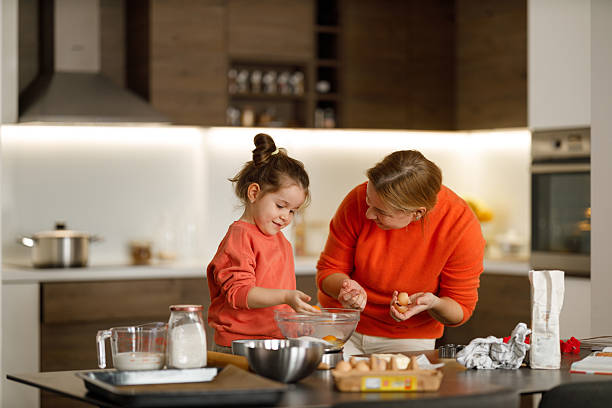 istock Mother and daughter baking 2215629148