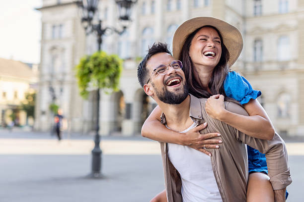 istock Couple laughing during piggyback ride outside historical building 2215629954