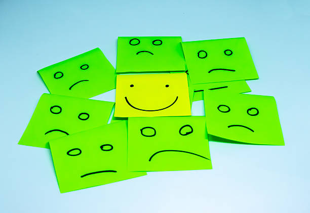 istock concept for a positive attitude with small office notes with multiple faces and one that stands out with a smile 2215638494