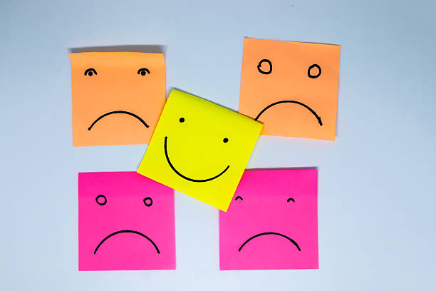 istock concept for a positive attitude with small office notes with multiple faces and one that stands out with a smile 2215638554