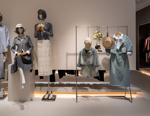 istock Mannequins display autumn clothes in store window 2215639697