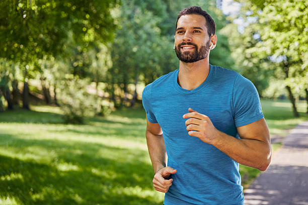 istock Handsome man running in park with earphones 2215652971