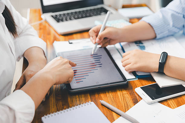 istock Teamwork meeting, business people in office workplace. Collaboration, technology and worker, employees with touchscreen planning sales, research or financial strategy, staff for conversation, graph 2215653552