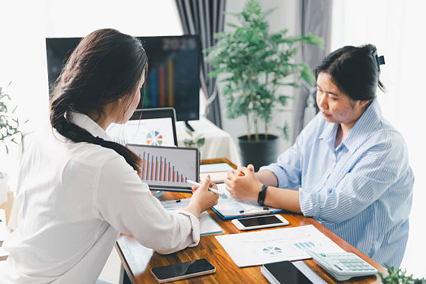istock People meeting using laptop computer, calculator, stock market chart paper for analysis plans to improve quality. Team working on project. Analysis business brainstorming corporate smart Concept. 2215653555