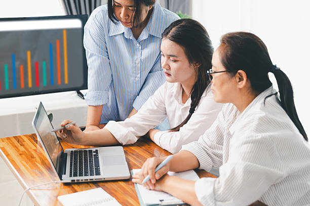 istock Teamwork meeting, business people in office workplace. Collaboration, technology and worker, employees with touchscreen planning sales, research or financial strategy, staff for conversation, graph 2215653573