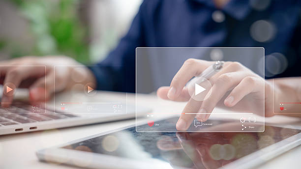 istock Hands using digital tablet and laptop to play video content on streaming platform. Concept of online media, content marketing, social network, video sharing, and digital communication. 2215654189