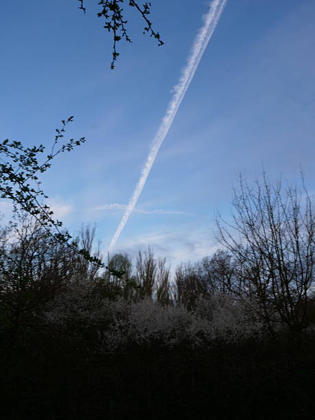 istock Vapor trails and cloudscape over countryside 2215655299