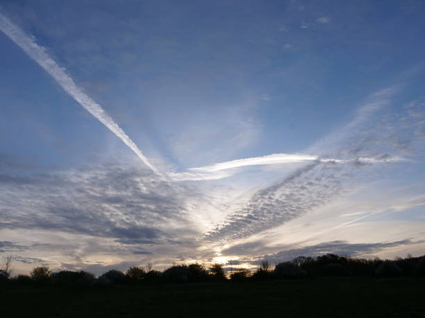 istock Vapor trails and cloudscape over countryside 2215655324