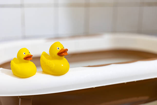 istock Two Yellow Rubber Ducks Resting on Bathtub Edge 2215660113