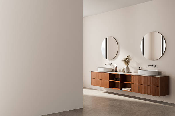 istock Modern bathroom interior with wooden vanity, double sinks, round mirrors and empty wall for poster mockup design template in clean minimalistic layout. 3D Rendering 2215661572