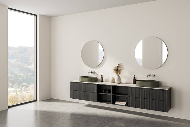 istock Modern minimalist bathroom interior with double vanity, green sinks, round mirrors, decor vases, large window, light walls, and concrete floor. 3D Rendering. 3D Rendering 2215661576