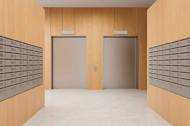 istock Modern apartment interior with twin elevators and metallic mailboxes on wooden walls in clean minimalist lobby design. 3D Rendering 2215662636