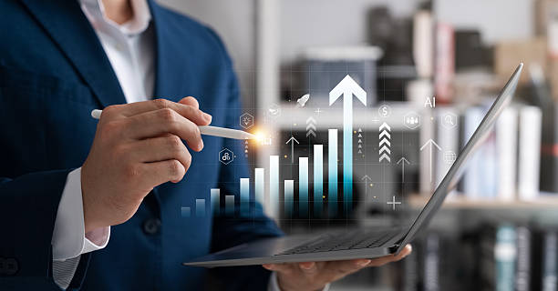 istock Businessman analyzing digital data on a laptop with AI-powered graph icons and growth arrows, representing business strategy, financial performance, and digital innovation. 2215671860