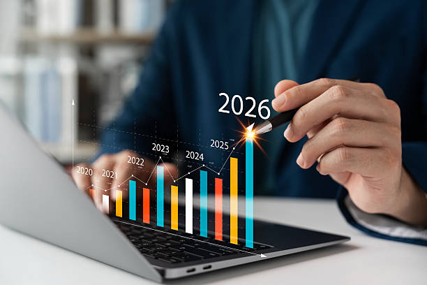 istock Businessman analyzing futuristic growth chart on laptop with rising bar graph from 2020 to 2026. Concept of financial forecast, digital investment, and long-term business strategy. 2215671936