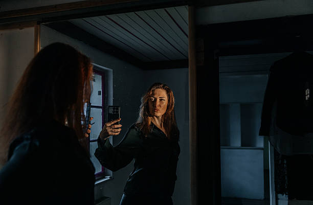 Confident mature caucasian female with red hair in leather jacket