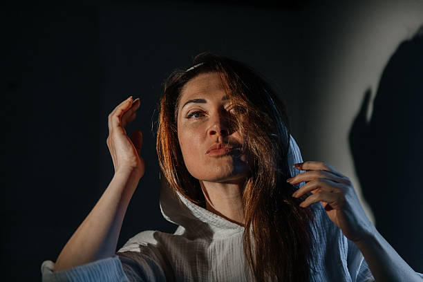 istock Contemplative young caucasian female in dramatic lighting 2215674449