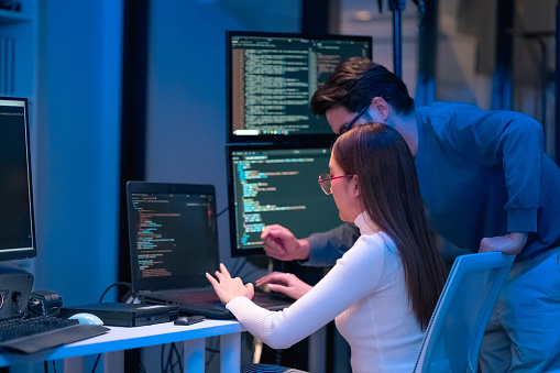 Asian Programmers Collaborating On Software Development At Night ...