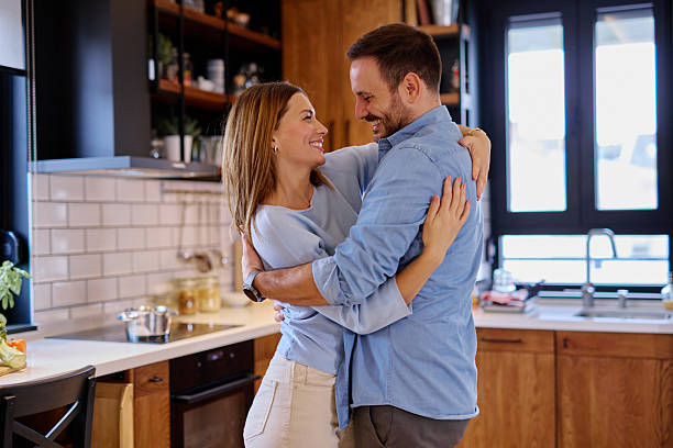 istock Happy couple dancing and hugging in kitchen 2215677622