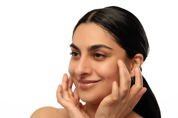 istock Woman Gently Touching Her Face With a Smile 2215678886