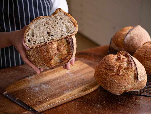 istock Baker's Hand Presenting Homemade Sourdough. 2215680401