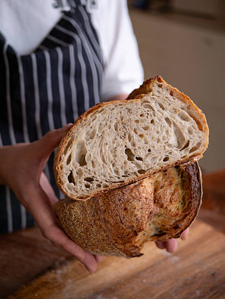 istock Baker's Hand Presenting Homemade Sourdough. 2215680422