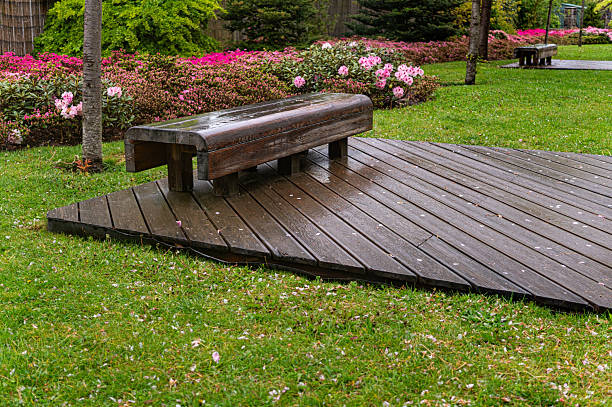 istock Wooden garden bench in the blooming spring park 2215681205
