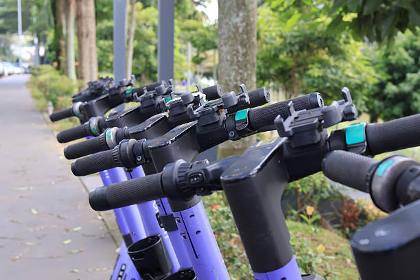 istock Electric scooters parked on urban sidewalk. 2215681868