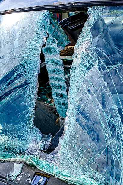 istock Damaged blue car with shattered windshield in a junkyard during daylight hours showcasing rust and decay 2215683406