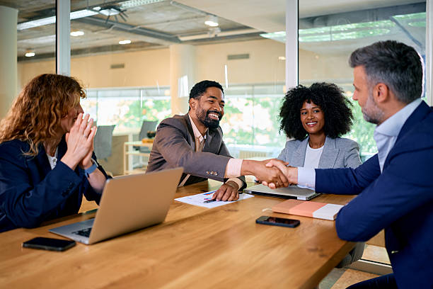 istock Businesspeople shaking hands during a meeting in a modern office 2215688119