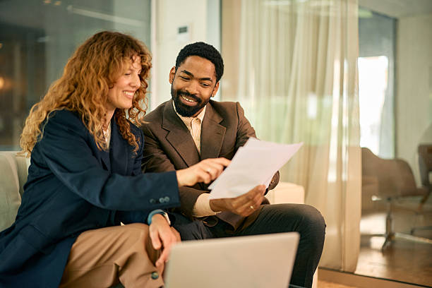 istock Business partners reviewing documents and working together in modern office 2215688339