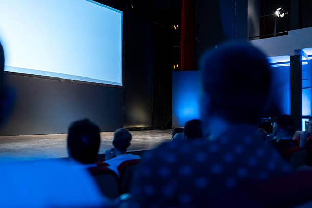 istock Audience gathers for an engaging presentation in a theater setting during an evening event 2215691458