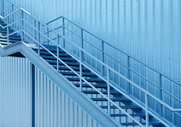istock A set of stairs ascending a large blue wall 2215695295